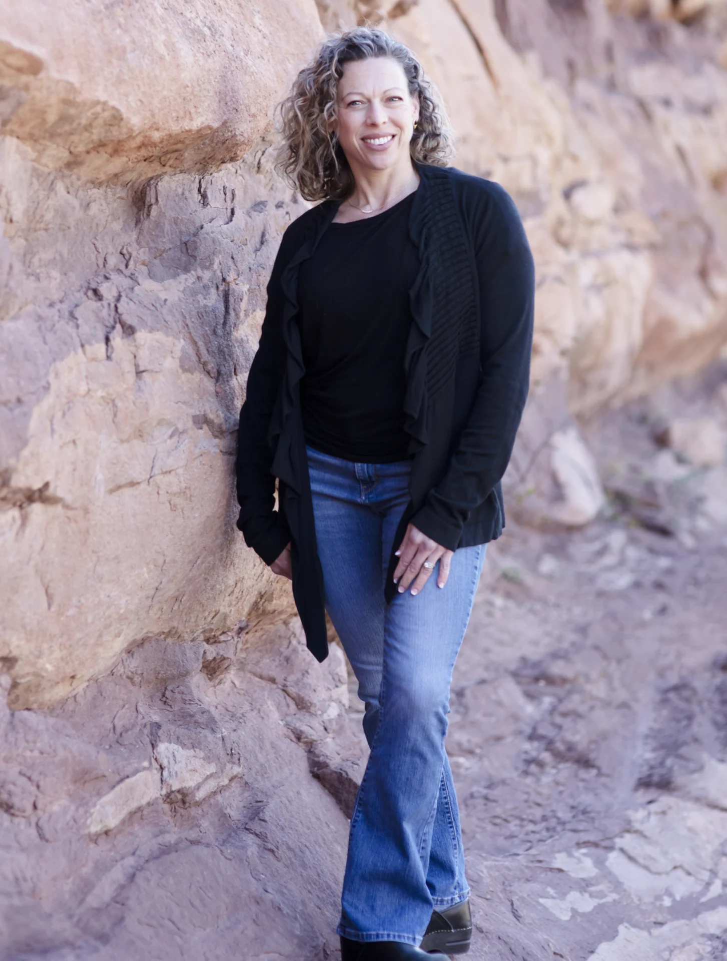 A woman standing in front of some rocks